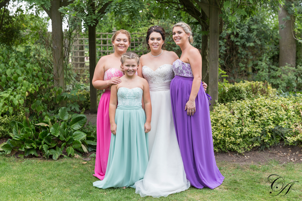 Wedding Photography from Sandburn Hall, Bride with her bridesmaids in the enclosed garden.